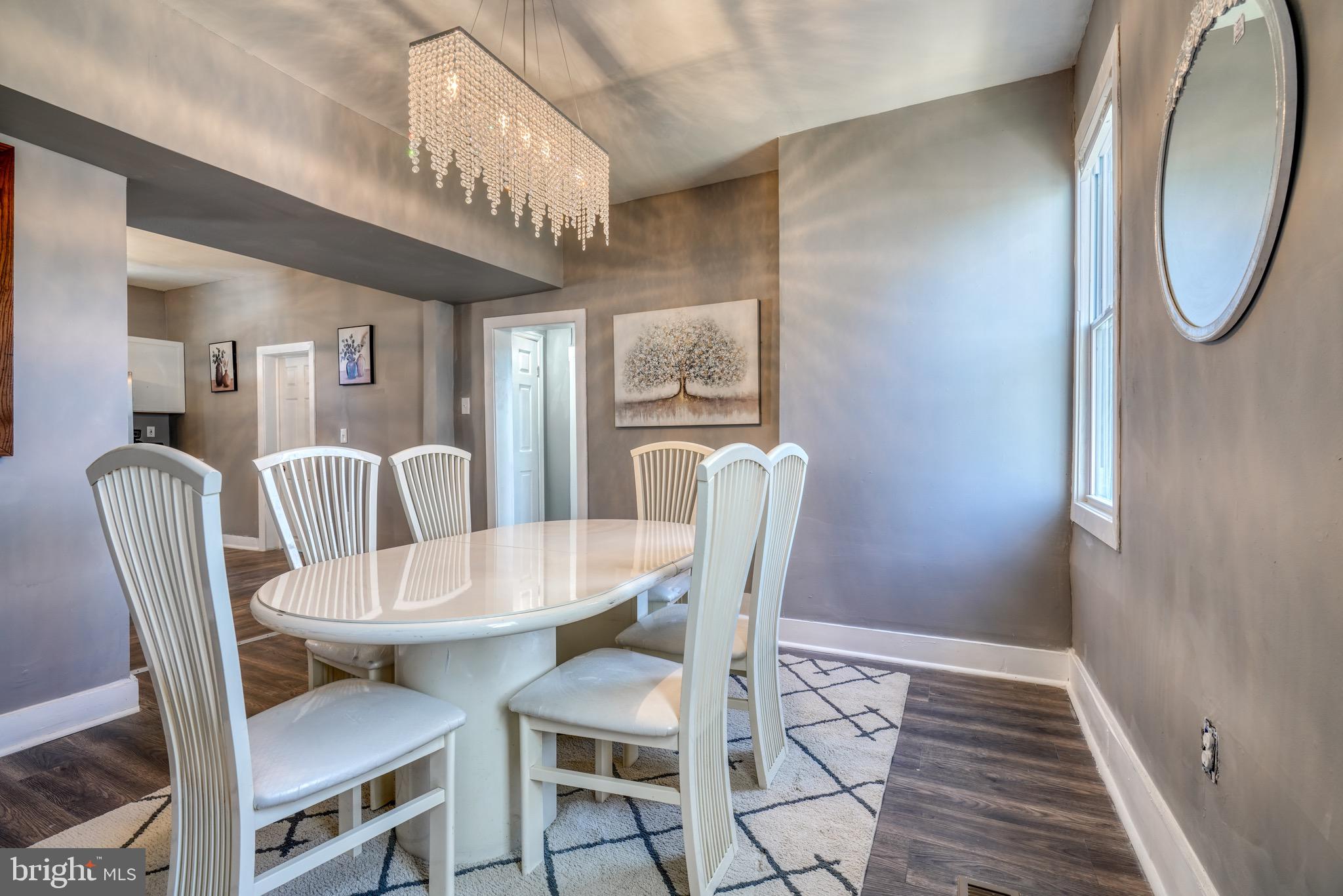 4107 Ridgewood Avenue Baltimore, MD 21215 - Photo 6 of 29 a view of a dining room with furniture and a chandelier