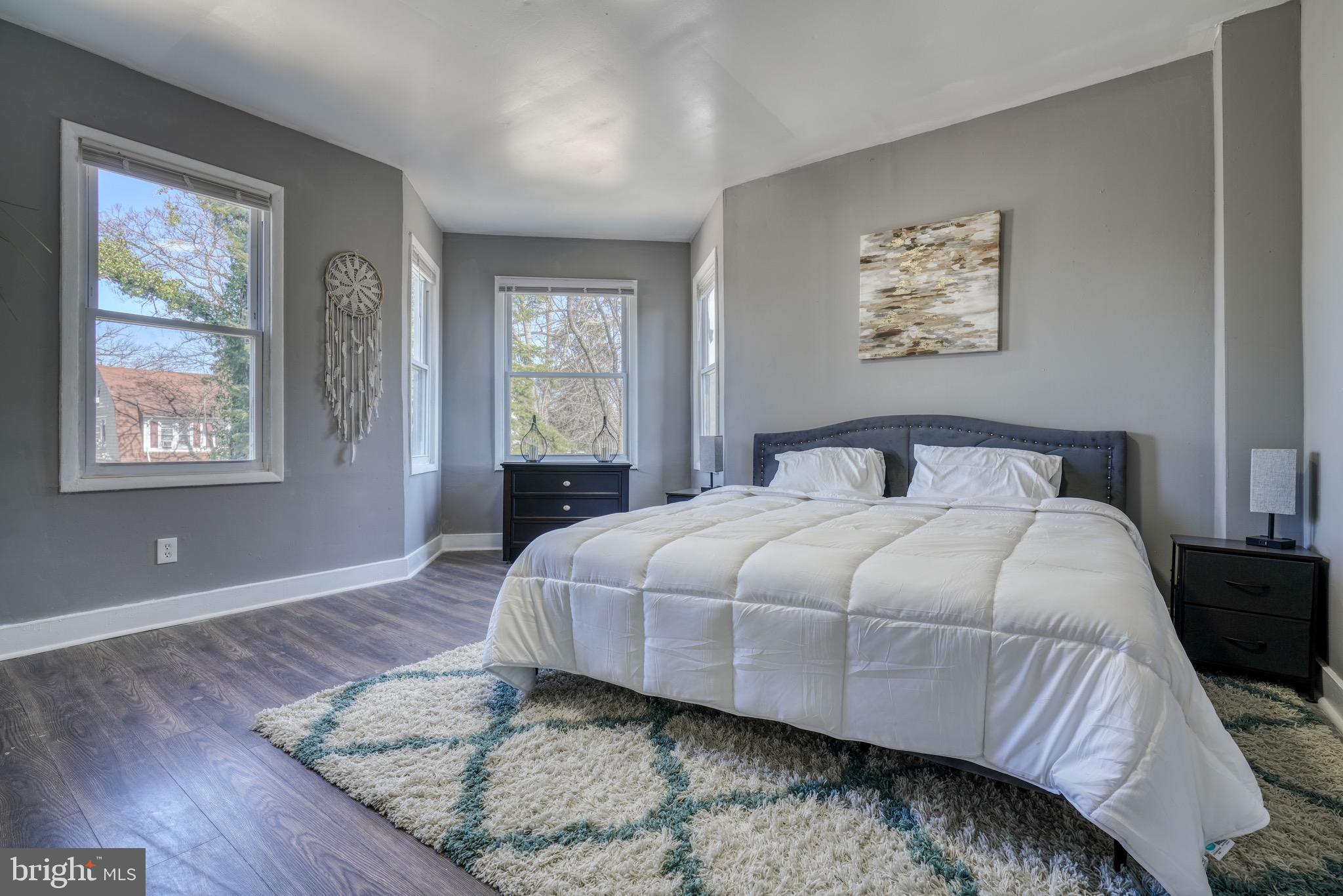 4107 Ridgewood Avenue Baltimore, MD 21215 - Photo 8 of 29 a bedroom with a bed and wooden floor