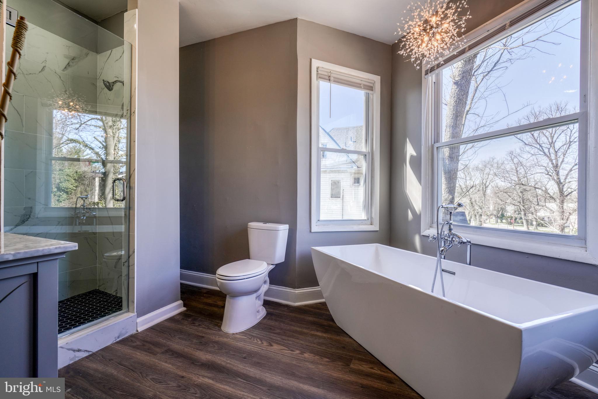 4107 Ridgewood Avenue Baltimore, MD 21215 - Photo 10 of 29 a bath room with a toilet a bath tub and a shower