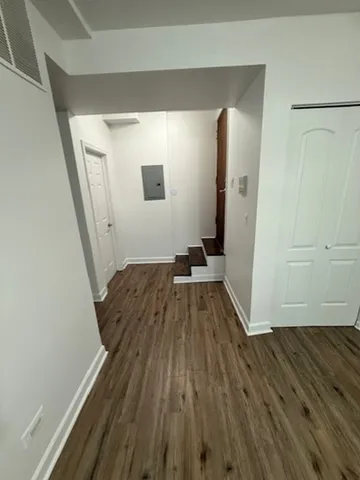 a view of a room with wooden floor and staircase