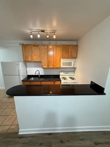 a view of a counter top that has a sink and a stove