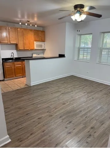 a kitchen with stainless steel appliances granite countertop a sink window and cabinets