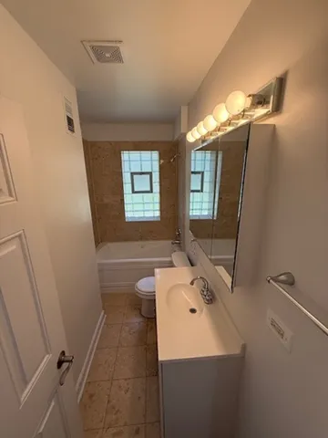 a bathroom with a sink toilet and tub