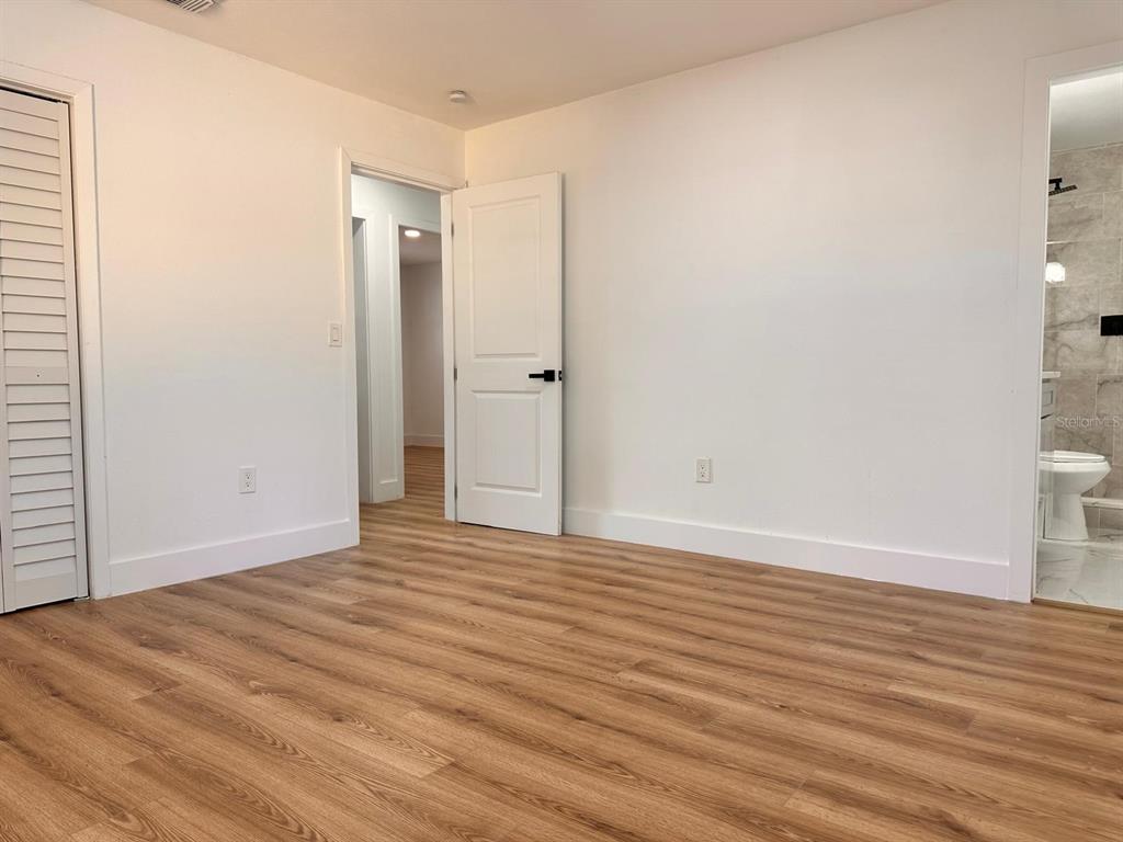933 Windsor Street Lakeland, FL 33803 - Photo 27 of 47 a view of an empty room with wooden floor and a window