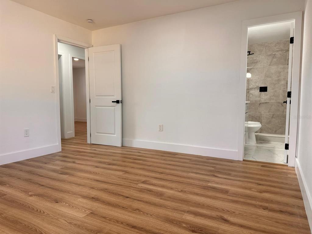 933 Windsor Street Lakeland, FL 33803 - Photo 28 of 47 a view of a room with wooden floor and bathroom