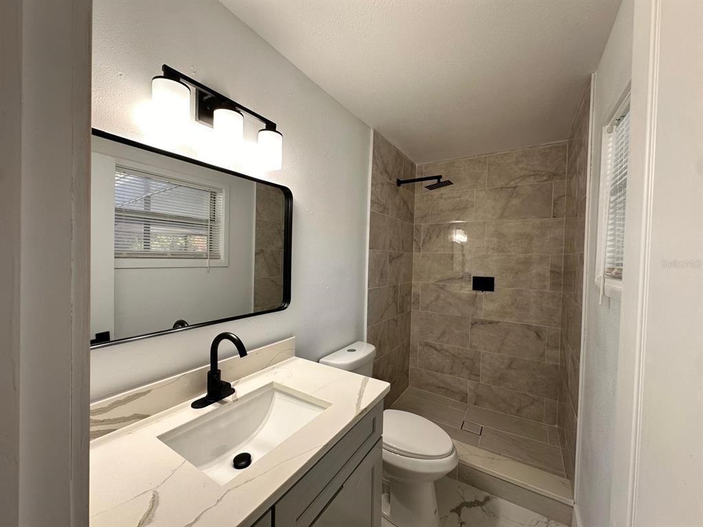 933 Windsor Street Lakeland, FL 33803 - Photo 33 of 47 a bathroom with a sink toilet and shower