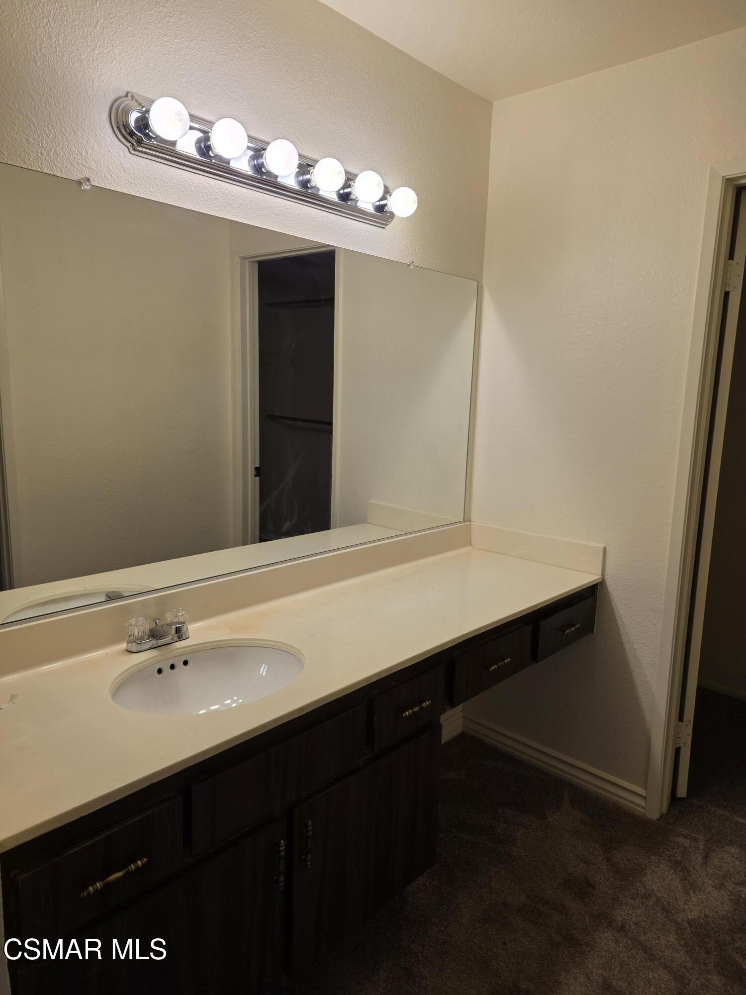 1778 Sinaloa Road, Unit 193 Simi Valley, CA 93065 - Photo 15 of 17 a bathroom with a sink double vanity and a mirror