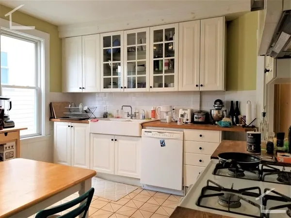a kitchen with stainless steel appliances a stove a sink and a refrigerator