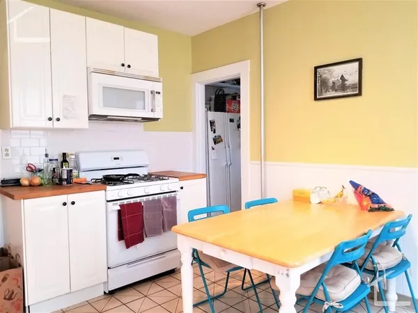 a kitchen with stainless steel appliances a stove a sink and a refrigerator