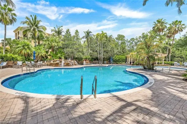 a view of a swimming pool with a yard
