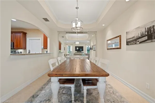 a view of a dining room with furniture and a chandelier