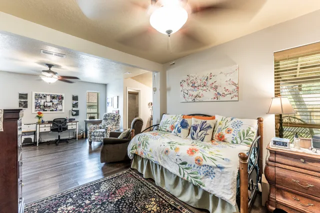 a bedroom with furniture and a large window