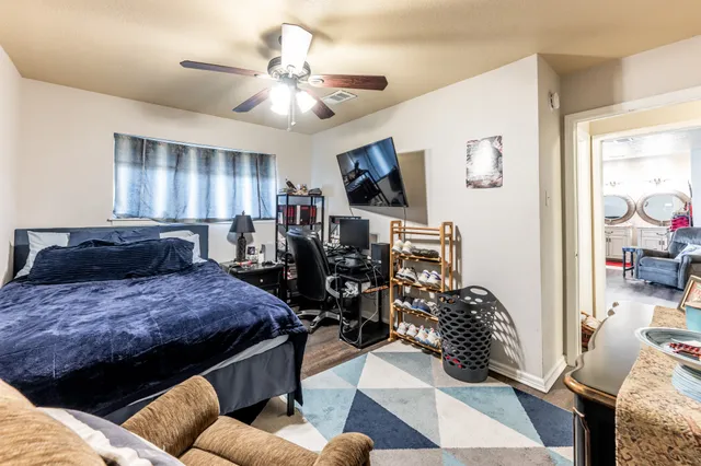 a bed room with furniture and a flat screen tv