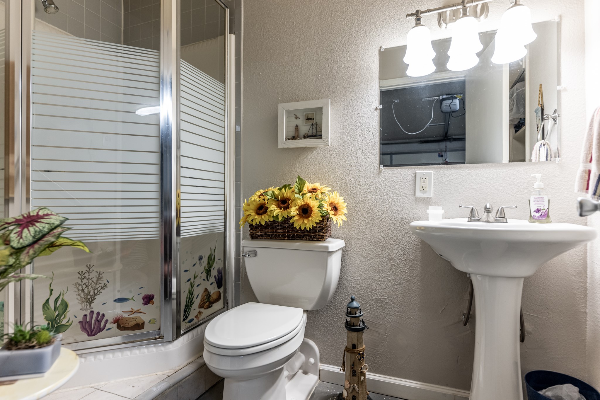 2115 Normal Park Drive Huntsville, TX 77340 - Photo 19 of 23 a bathroom with a sink toilet and a mirror