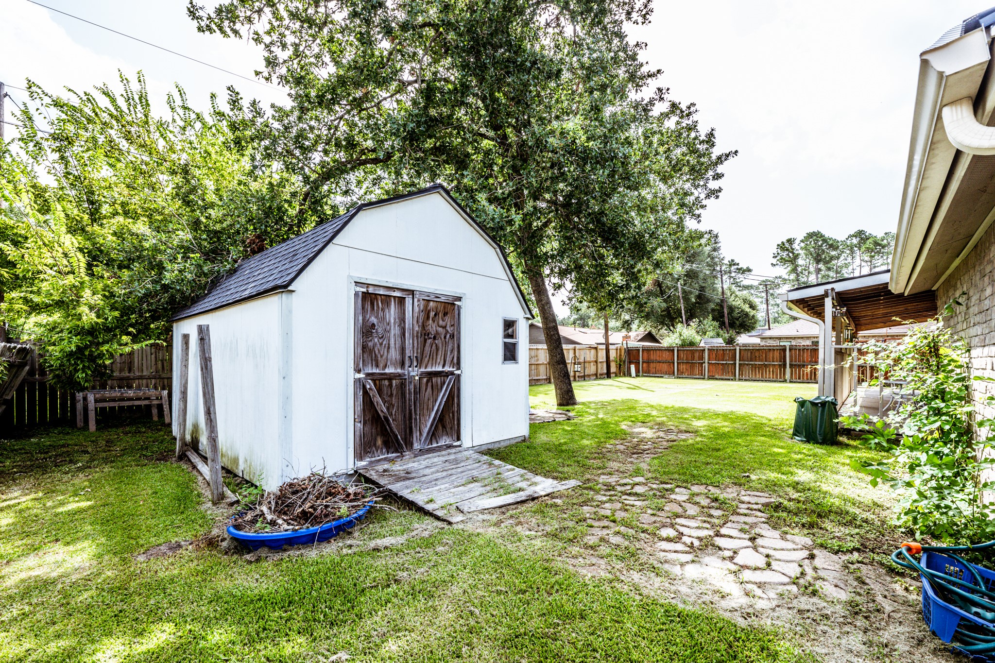 2115 Normal Park Drive Huntsville, TX 77340 - Photo 22 of 23 a view of backyard with a garden and trees
