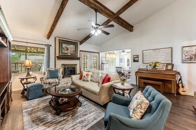 a living room with furniture a fireplace and a flat screen tv