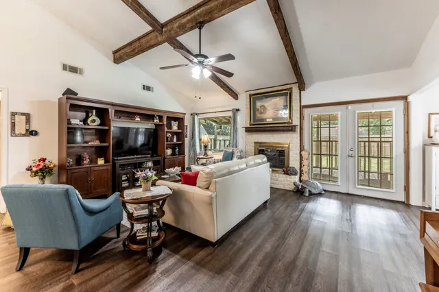 a living room with furniture a flat screen tv and a fireplace