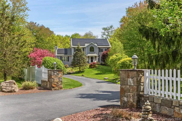 a front view of a house with a yard and a fence