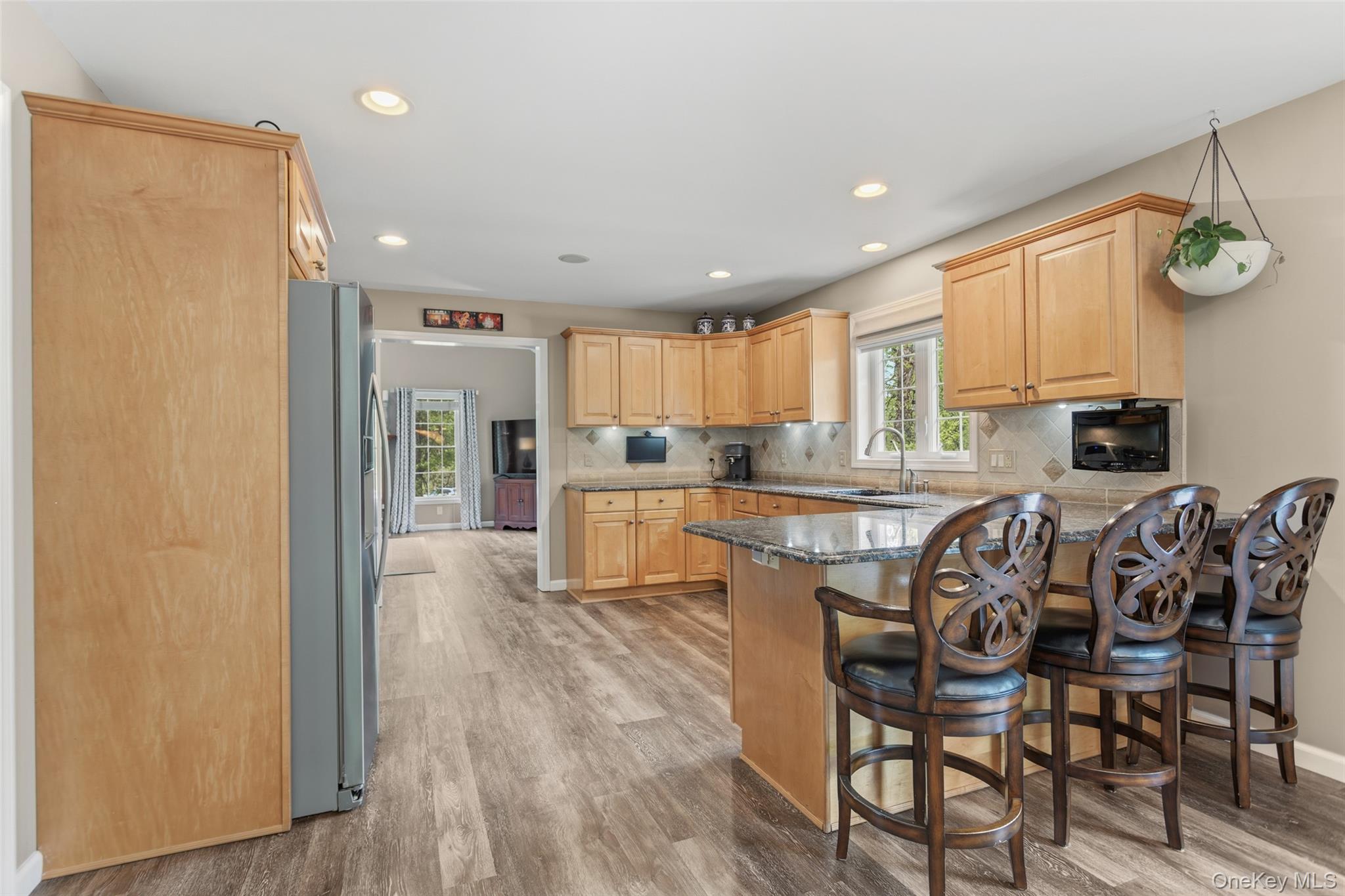 754 Milltown Road Danbury, CT 06811 - Photo 13 of 41 a kitchen with granite countertop stainless steel appliances a table and chairs in it