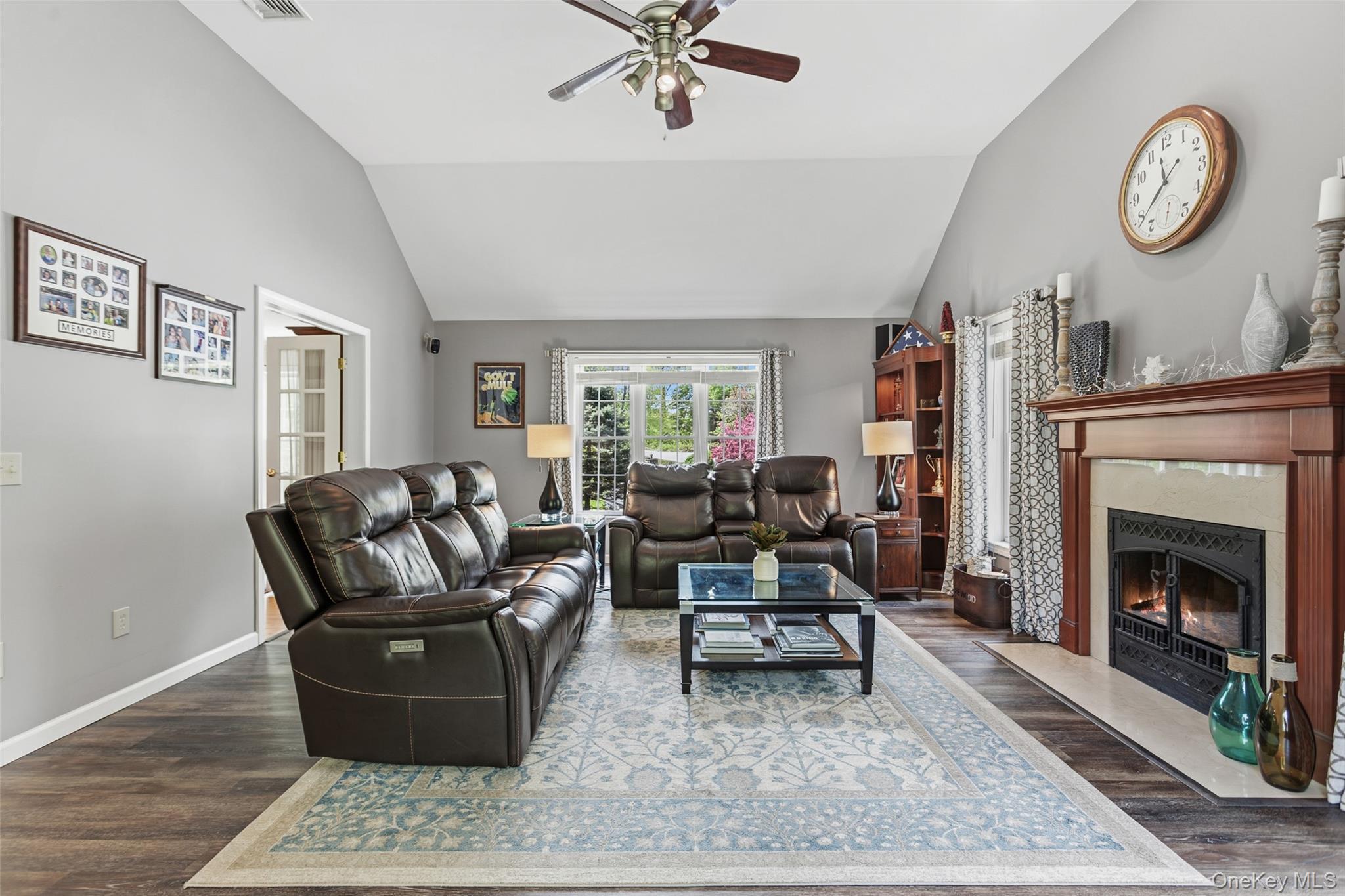 754 Milltown Road Danbury, CT 06811 - Photo 20 of 41 a living room with furniture a clock and a fireplace