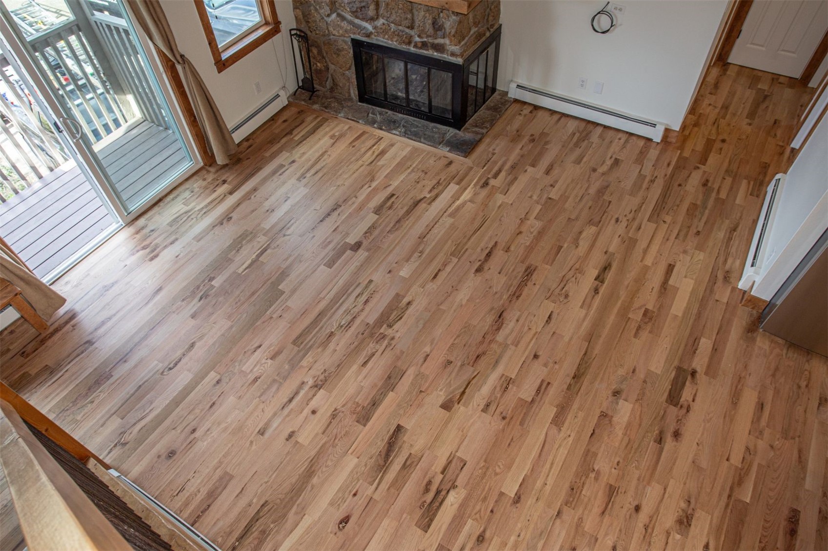 602 Ryan Gulch Road, Unit B Silverthorne, CO 80498 - Photo 9 of 34 Unfurnished living room with light wood-type flooring, and a stone fireplace