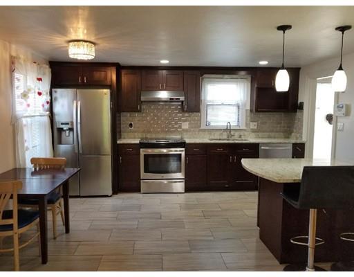 a kitchen with stainless steel appliances granite countertop a sink a stove a refrigerator and island