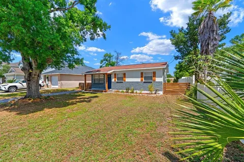a view of a house with swimming pool and sitting area
