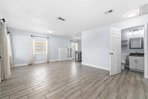 a view of a kitchen with wooden floor and a sink