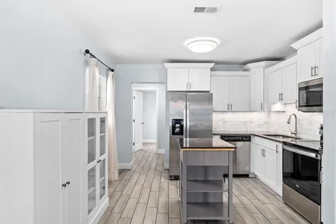 a kitchen with cabinets and stainless steel appliances