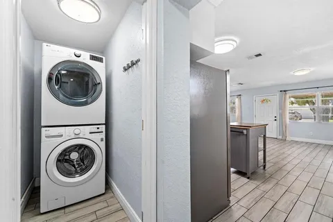 a view of a hallway with washer and dryer