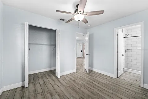 a view of an empty room with wooden floor