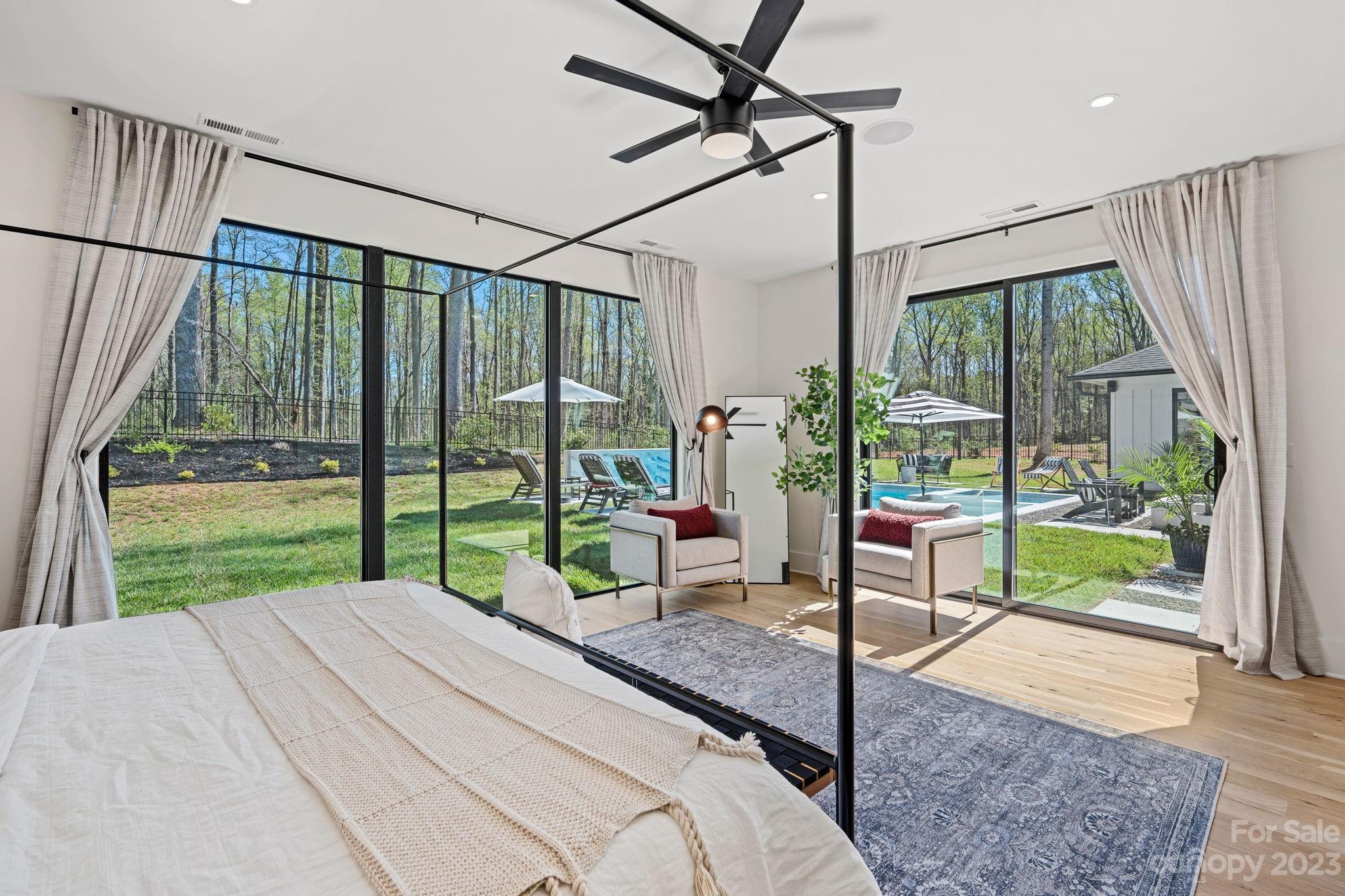 9622 Beatties Ford Road Huntersville, NC 28078 - Photo 20 of 48 a bedroom with a bed and large window with balcony view