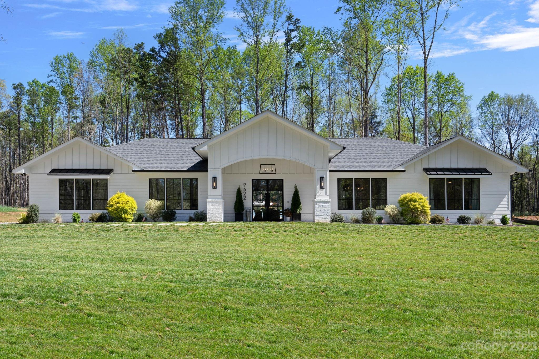 9622 Beatties Ford Road Huntersville, NC 28078 - Photo 2 of 48 a front view of a house with a garden
