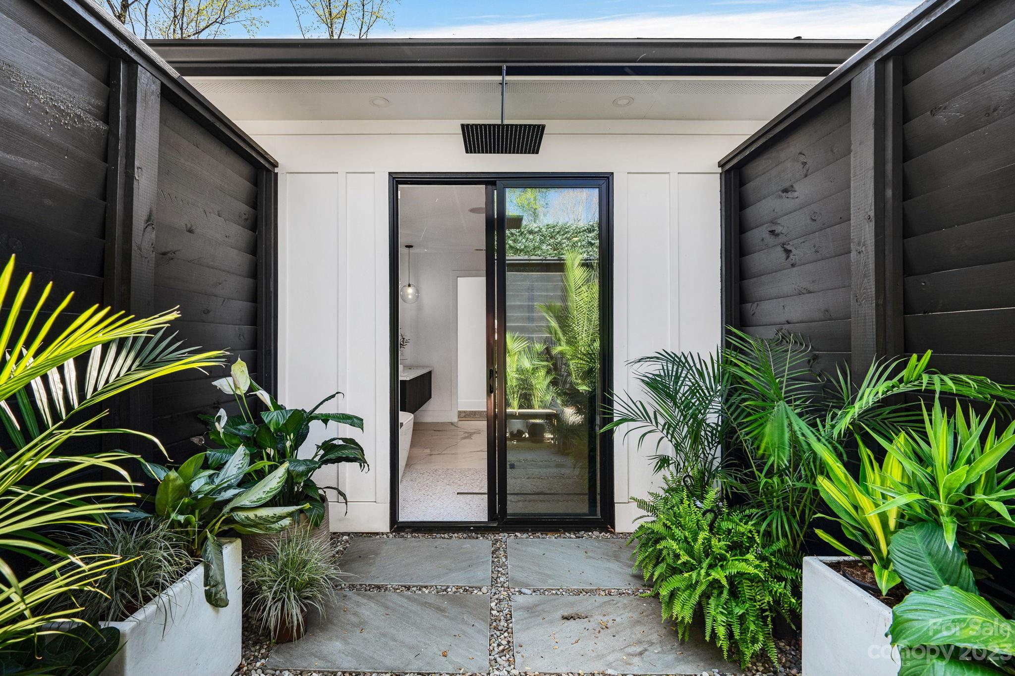 9622 Beatties Ford Road Huntersville, NC 28078 - Photo 22 of 48 a potted plant in front of a door