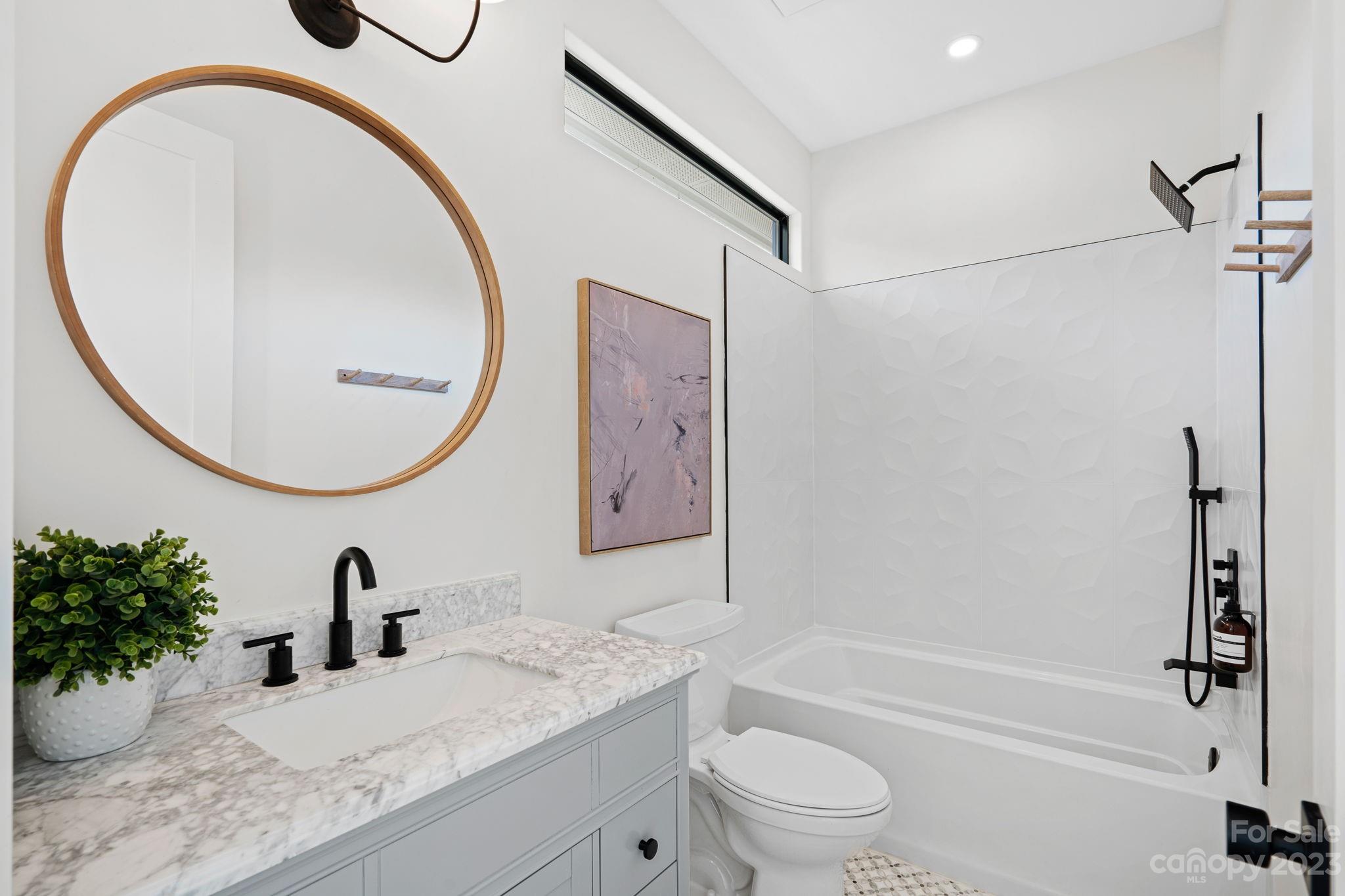 9622 Beatties Ford Road Huntersville, NC 28078 - Photo 33 of 48 a bathroom with a granite countertop sink a toilet and a mirror
