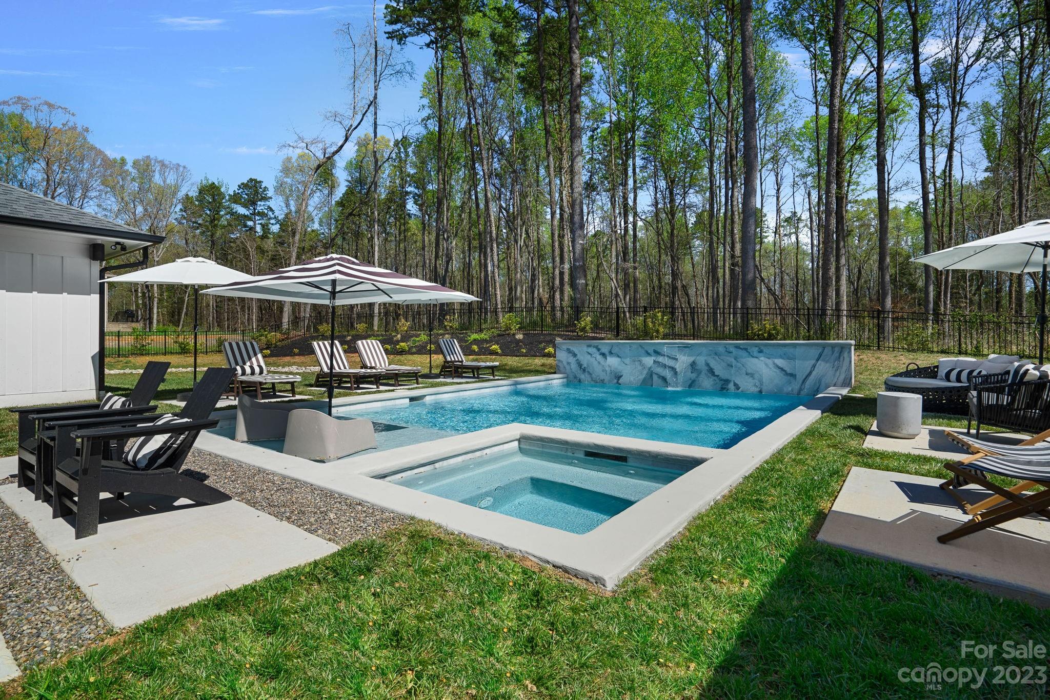 9622 Beatties Ford Road Huntersville, NC 28078 - Photo 46 of 48 a view of a backyard with swimming pool and sitting area