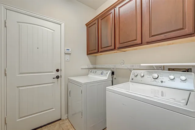 an empty room with windows and chandelier