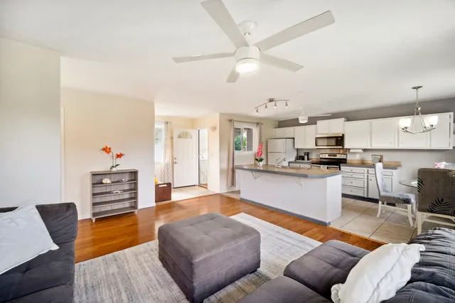 a living room with furniture and kitchen view