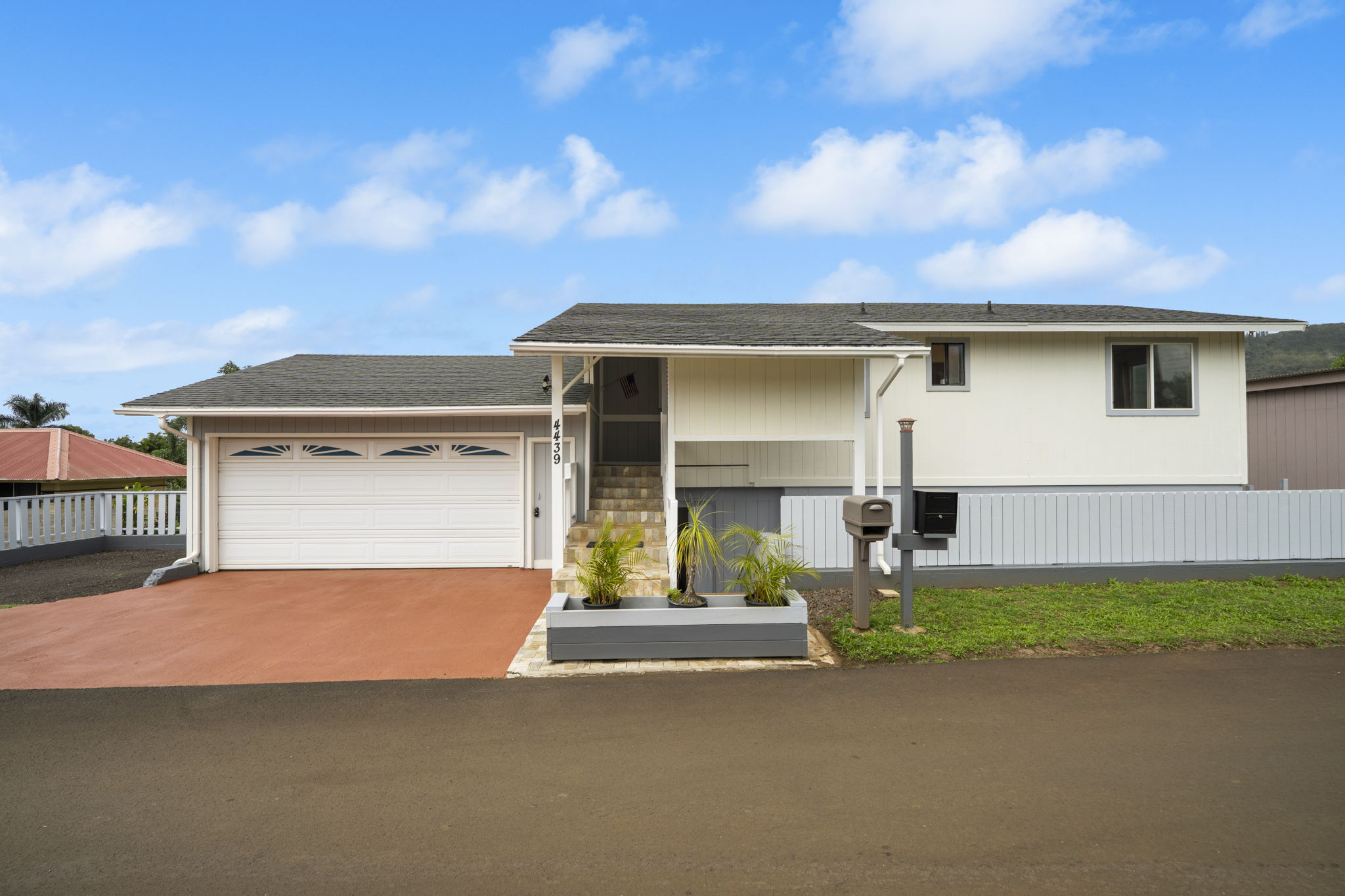4439 Punee Road Koloa, HI 96756 - Photo 6 of 30 a front view of a house with a yard and garage