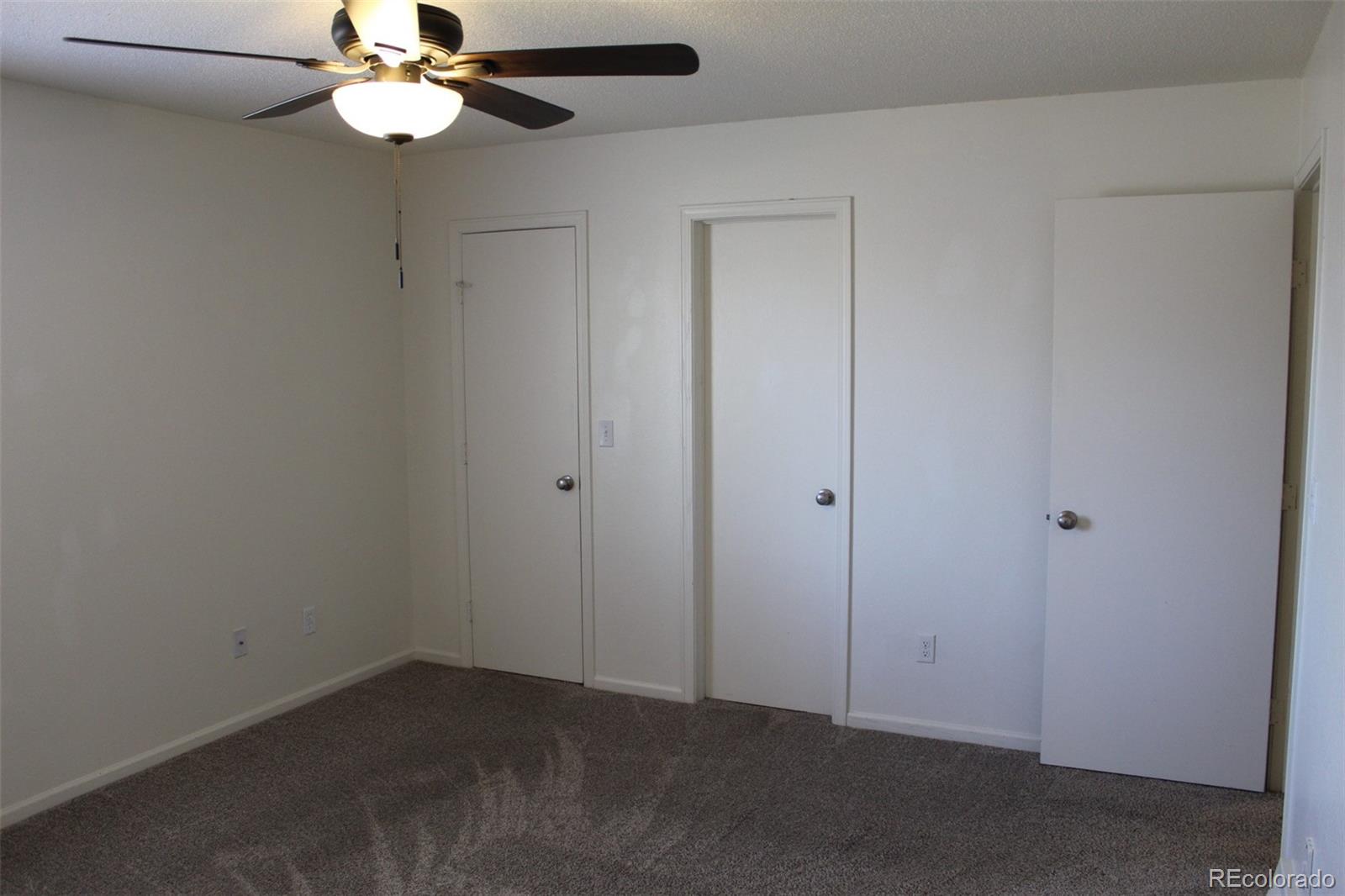 138 48th Avenue Greeley, CO 80634 - Photo 11 of 29 an empty room with a chandelier fan
