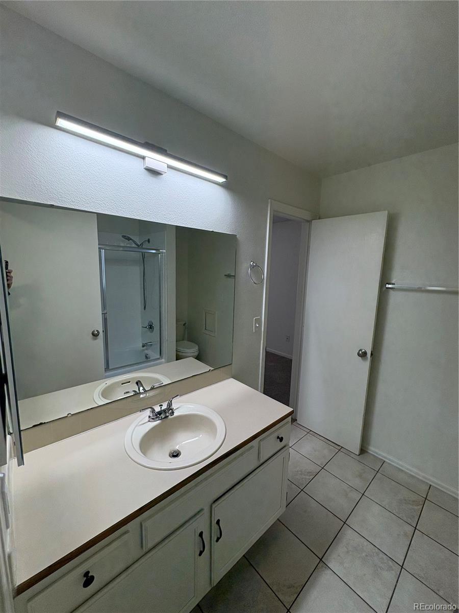 138 48th Avenue Greeley, CO 80634 - Photo 12 of 29 a bathroom with a sink and a mirror
