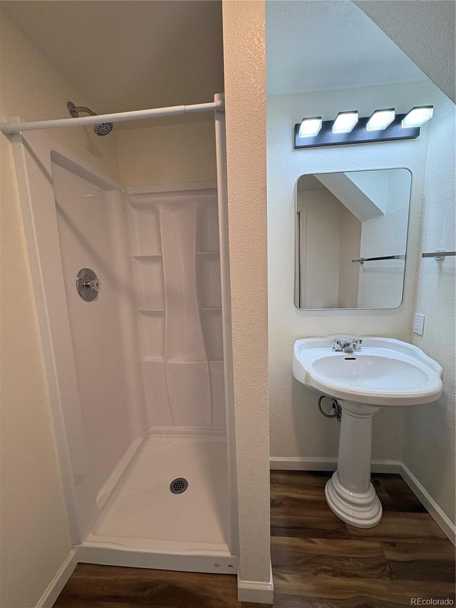 138 48th Avenue Greeley, CO 80634 - Photo 17 of 29 a bathroom with a sink a mirror and shower