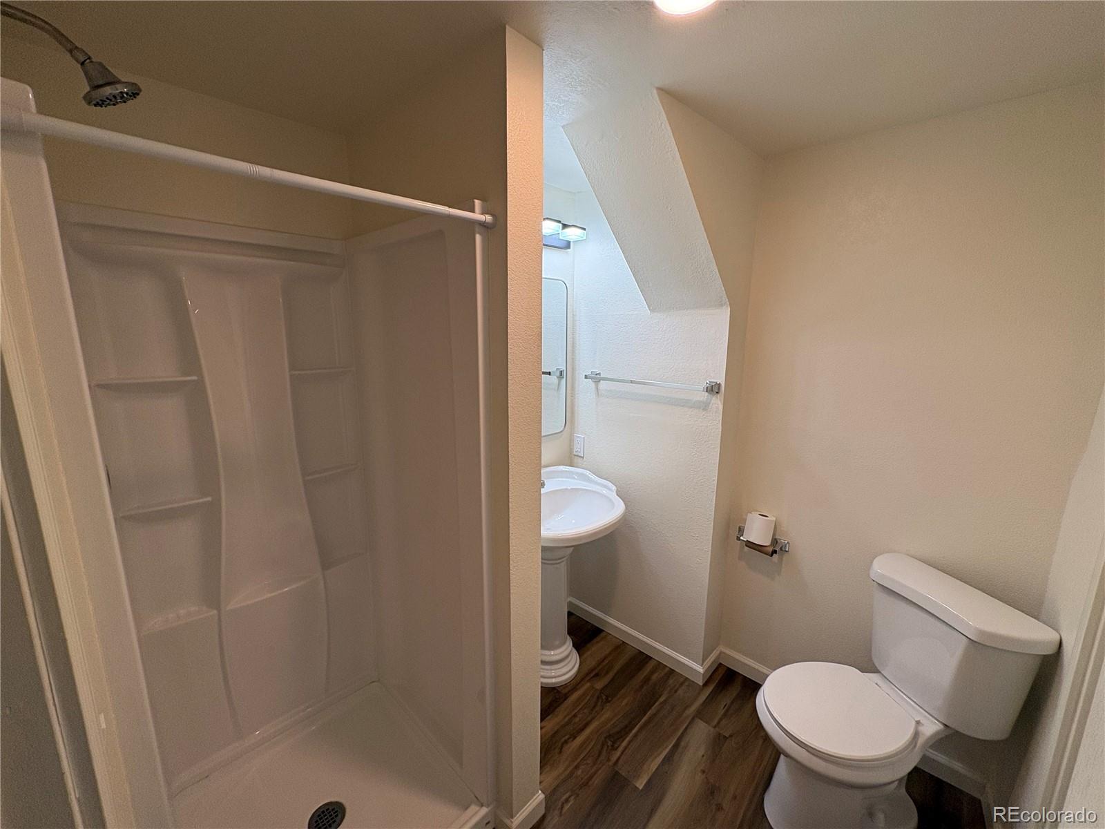 138 48th Avenue Greeley, CO 80634 - Photo 19 of 29 a white toilet sitting next to a shower