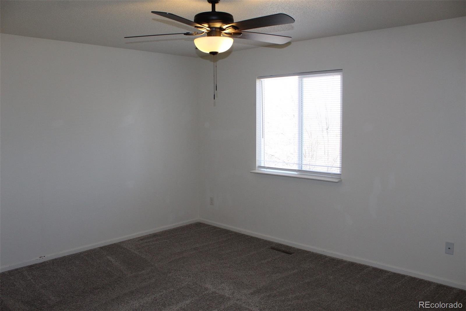 138 48th Avenue Greeley, CO 80634 - Photo 10 of 29 an empty room with a window and a fan