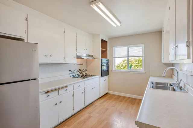 a kitchen with sink cabinets and window