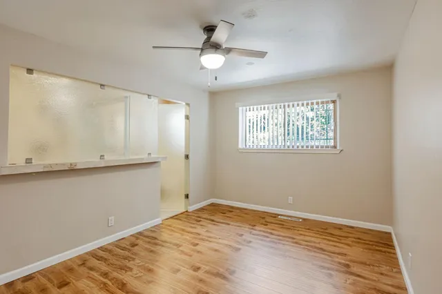 a view of a kitchen with a sink and wooden floor