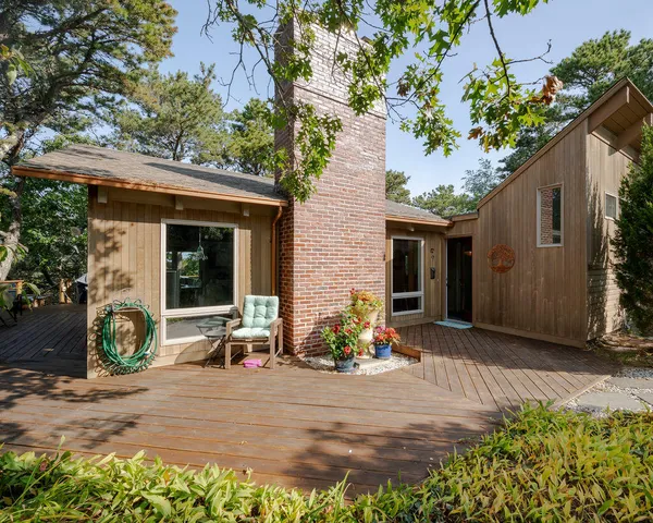 a front view of a house with a yard and seating space