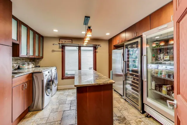a view of a swimming pool with a table and chairs under an umbrella