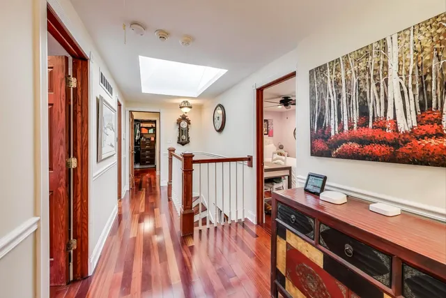 a view of a house with a big yard and large trees