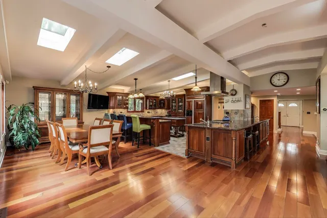 a kitchen with granite countertop a sink a counter top space appliances and cabinets